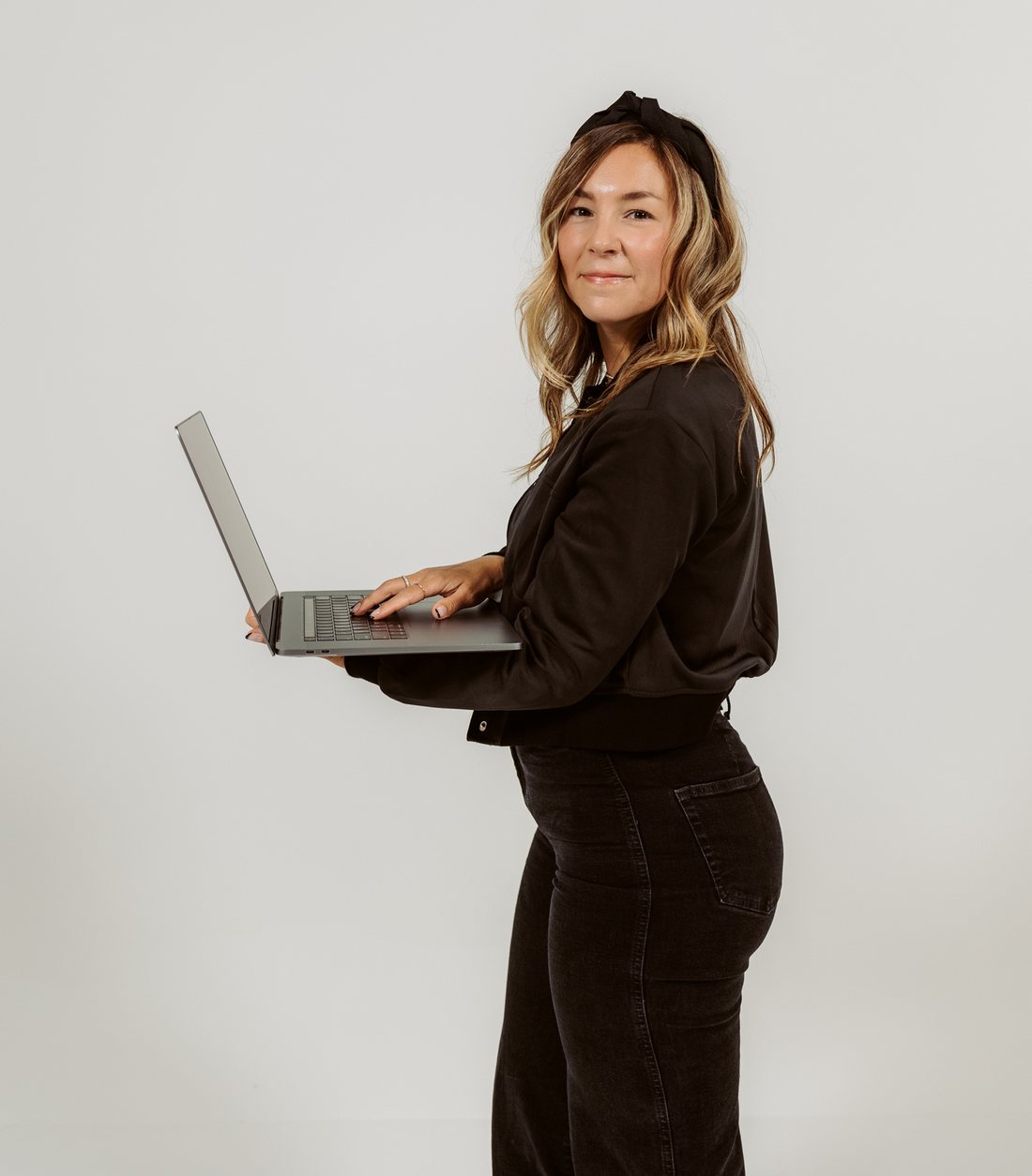 Tamra Fisher working on a laptop