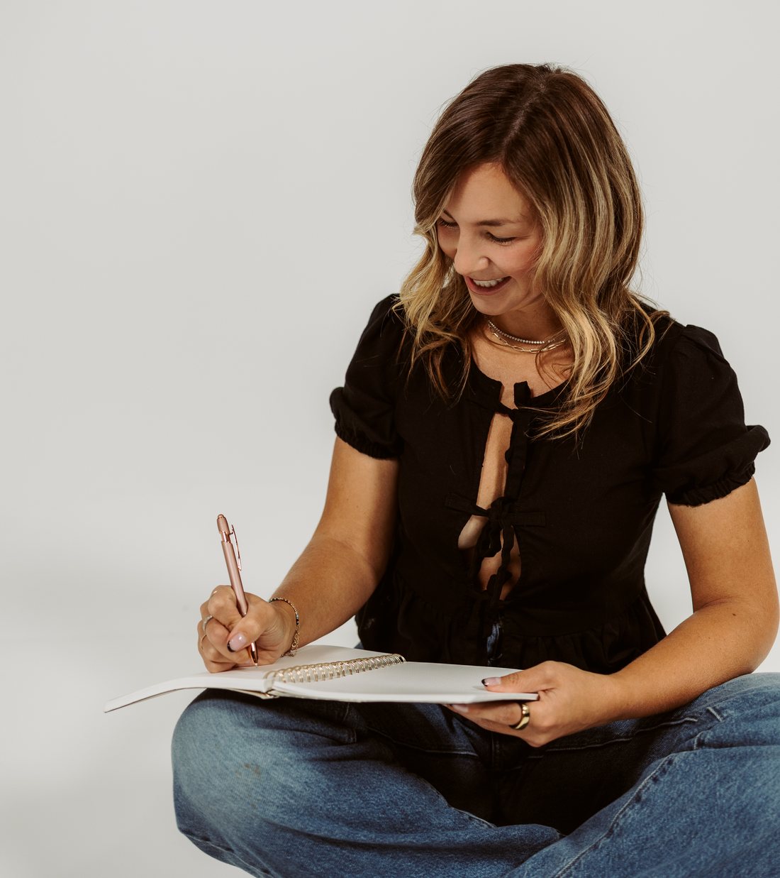 Tamra writing in a notebook